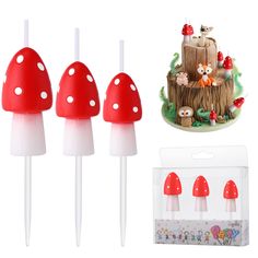 three red and white mushrooms are next to some toothpicks in the shape of trees