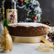 a cake sitting on top of a pan covered in frosting next to christmas decorations