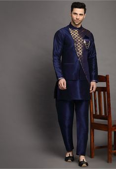 Art Silk Kurta in Navy Blue This Readymade attire is Enhanced with Buttons. Crafted in Chinese Collar Neck and Full Sleeve Available with an Art Silk Pajama in Navy Blue and an Art Brocade Silk Nehru Jacket in Navy Blue Do note: Brooch and Footwear shown in the image is for presentation purposes only. Half to one inch may vary in measurement. (Slight variation in actual color vs. image is possible) Indigo Festive Sets For Transitional Season, Blue Bandhgala For Navratri Designer Wear, Blue Bandhgala With Zari Work For Navratri, Long Sleeve Blue Sherwani For Navratri, Blue Long Sleeve Sherwani For Navratri, Blue Nehru Jacket With Cutdana For Wedding, Wedding Blue Nehru Jacket With Cutdana, Royal Kurta With Zari Work For Festive Occasions, Royal Festive Kurta With Zari Work