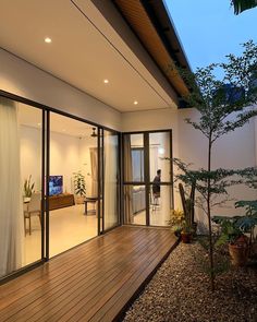 the inside of a house with wood floors and sliding glass doors