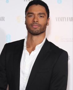 a man in a black suit and white shirt