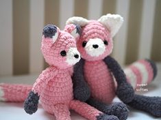 two crocheted stuffed animals sitting next to each other