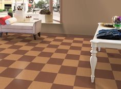 a living room filled with furniture and a checkerboard pattern on the floor in front of a window