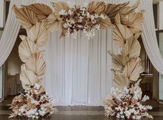 a wedding arch decorated with flowers and leaves for an entrance to the reception hall or ceremony room