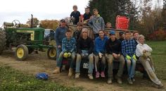 a group of people sitting on the back of a tractor