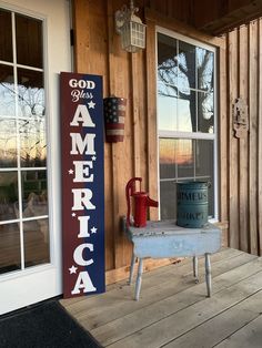 a sign that says god loves america on the side of a building next to a door