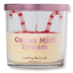 a candle with candy canes in it and the words cocoamint dream inside