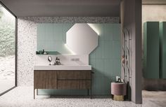 a bathroom with a sink, mirror and green tiles on the wall next to it