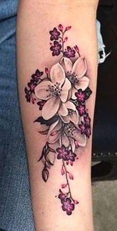 a woman's arm with flowers on it