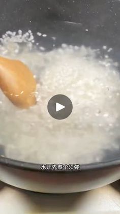 a frying pan filled with white rice and an orange spoon