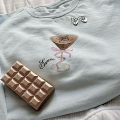 a chocolate bar and t - shirt on a bed