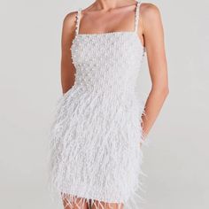 a woman wearing a white feather dress