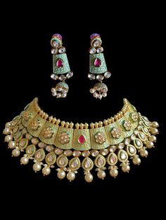 This beautiful kundan meena choker comes in a gorgeous pastel beads and gold plating. The set is lightweight and can easily be worn separately for a lighter and simple look. The finishing is done in gold and is completely handmade with intricate work. Only one piece in stock, I have this is 2-3 colors! The meenakari work is very high quality and the choker comes with matching jhumka Gold Kundan Choker Necklace, Gold Meenakari Lehenga For Gift, Gift Gold Lehenga With Meenakari Detail, Kundan Choker Sets In Temple Jewelry Style, Kundan Temple Jewelry Sets With Choker, Luxury Meenakari Temple Jewelry Sets, Gold Chandbali Choker With Meenakari, Gold Kundan Choker With Gota Work, Festive Gold Choker With Gota Work