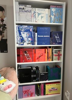 a white book shelf filled with lots of books