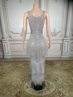 This Maxi Rhinestones Stones Dress is a stunning piece of clothing. It is made with Women`s crystals and Rhinestone, and is plated with Silver Plated, Plated, and Alloy. It is perfect for any special occasion, such as an anniversary or a party. This dress is truly innovative, with its unique design and intricate details. It is sure to make you stand out in any crowd. Plus, it is made to order, so you can be sure that it will fit you perfectly. Please note that this is a made to order item and wi Luxury Embellished Evening Dress For Glamorous Events, Glamorous Floor-length Dress With Rhinestones, Glamorous Rhinestone Evening Dress For Party Season, Glamorous Evening Dress With Rhinestones For Party Season, Embellished Sleeveless Dress For Glamorous Events, Glamorous Rhinestone Fringe Prom Evening Dress, Sleeveless Evening Dress With Rhinestone Fringe For Wedding, Champagne Gala Dress With Rhinestones, Elegant Sparkling Evening Dress For Glamorous Events