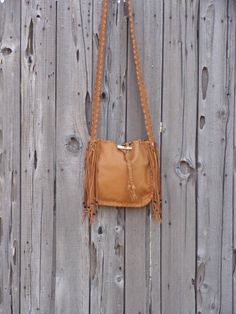 This leather tote is a great size for your every day needs. This bag is made of saddle tan leather and is 10 inches tall, 10 inches wide and 2.75 inches deep. We can make this bag in any of the colors of leather you see in our shop. It has an extra pocket inside and a comfortable 48 inch flat strap. Let us know how long you like your strap. We can make this bag in a variety of colors of soft tanned cowhide ( see the last photo ). Just leave a note at check out or contact us... This item is MADE Camel Crossbody Shoulder Bag With Leather Handles, Leather Hobo Bag For Fall, Fall Camel Shoulder Bag With Adjustable Strap, Camel Satchel Shoulder Bag For Fall, Brown Fringe Bags For Daily Use, Brown Fringe Bag For Daily Use, Daily-use Brown Bag With Fringe, Daily Use Brown Fringe Bag, Fringe Bucket Tote Bag