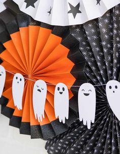 some paper fans with ghost decorations on them