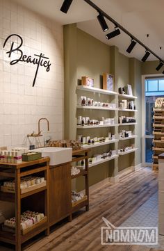 the inside of a beauty store with shelves and sinks in front of it's counter