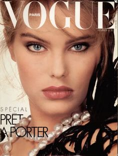 a woman with blue eyes is featured on the cover of a magazine, wearing pearls