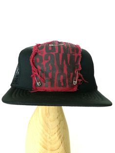 Black foam and mesh trucker hat with Punk Rawk Show maroon red patch pinned on front with safety pins. Distressed fabric on print patch. Otherwise very good used condition. Punk Cap Hat One Size Fits Most, Punk Style Cap Hat, Punk Style Cap One Size Fits Most, Vintage Trucker Hat With Flat Brim For Streetwear, Distressed Adjustable Hat For Streetwear, Distressed Cap For Streetwear, Vintage Short Brim Snapback Hat For Streetwear, Punk Style Hat For Streetwear, One Size Fits Most, Vintage Flat Brim Trucker Hat For Streetwear