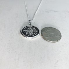 "Do you love to travel? This handmade silver charm is perfect for those who love adventure! The pendant measures approximately 3/4\" and is made from .999 fine (pure) silver. Each pendant is handmade by me in a multiple step process until it becomes a pendant that resembles the old fashioned wax seals found on vintage envelopes. Every pendant will be unique and have its very own \"personality\". I believe in perfect imperfections, so the way it comes out of the batch is how it is meant to be. I Sterling Silver Necklace With Round Pendant For Travel, Sterling Silver Round Pendant Jewelry For Travel, Silver Pendant Jewelry For Travel, Sterling Silver Compass Necklace For Travel, Silver Medallion Charm Necklace With Compass Design, Sterling Silver Compass Design Necklace For Travel, Engraved Medallion Necklace For Travel, Silver Medallion Necklace For Travel, Personalized Pendant Necklaces For Travel