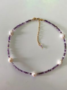 "This charming Necklace is made of Amethyst  and irregular Freshwater Pearl , complemented by gold-plated steel Beaded. Finished with gold-plated steel elements that guarantee the durability of the jewelry.  Its light appearance makes it suitable for any outfit, both jeans and a white t-shirt, and the \"little black dress\". -The necklace has a length of approximately 39 cm + 6,5 cm extension Amethyst beads- 4 mm Freshwater Pearl - 10-11 mm This elegant necklace is a perfect addition to evening dresses or everyday outfits. This necklace is an ideal gift for a loved one or a wonderful way to treat yourself! This necklace emanates good energy because I made it with joy and passion, just like all of my creations!  *This necklace comes with an chain extension, so your can increase or decrease Purple Amethyst Pearl Necklace, Handmade Purple Pearl Necklace With Round Beads, Purple Amethyst Pearl Necklace With Gemstone Beads, Purple Amethyst Gemstone Beads Pearl Necklace, Handmade Amethyst Pearl Necklace Gift, Handmade Purple Pearl Necklace For Gift, Handmade Amethyst Pearl Necklace As A Gift, Purple Gemstone Pearl Necklace Gift, Pearl Beaded Necklace