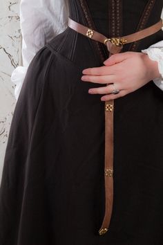 A historical renaissance costume inspired by the Spanish 16-century court and stories of passion in the dark corridors of Escorial palace. The dress was developed based on 16th and 17th-century paintings. With its conical tight corset, wide skirt, and long removable sleeves, as well as dark coloring, the costume bears a distinguishing mark of 16th-17th century Spanish fashion, which has been quite popular in Europe. The costume consists of a skirt, an adjustable corset, a chemise, and a beret. A 16th Century Dress, Ren Faire Dress, Faire Dress, Medieval Wedding Dress, Spanish Dress, Historical Dress, Century Dress, Spanish Fashion, Cocoa Brown