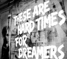 graffiti on the side of a building that says, these are hard times for dreamers