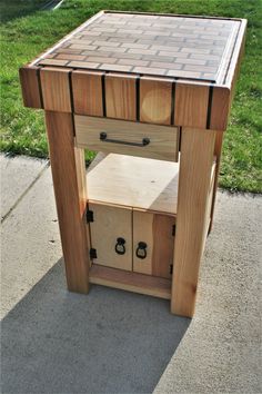 a small wooden table with drawers on it