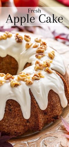 a close up of a cake on a plate with frosting and nuts around it