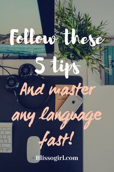 a laptop computer sitting on top of a desk with the words follow these 5 tips and master any language fast