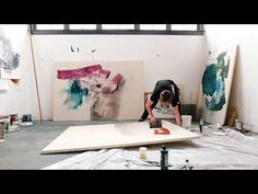 a man is painting in an art studio