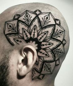 a man's head with an intricate tattoo on it