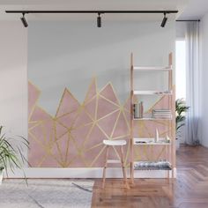 a pink and gold geometric wall mural in a living room