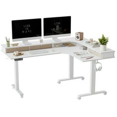 two computer monitors sitting on top of a white desk