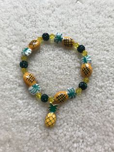 "Adorable Glass blown Pineapples are surrounded by an array of crystal and rhinestone beads to make up this fun bracelet!  There is a gold plated enamel pineapple charm dangling in the center.   It stretches to fits up to a 7\" wrist.   Comes wrapped in a gift giving bag with tie. In stock items ship within 2-3 business days.  Custom orders can take up to 10 days. Shipping Time - Please allow 3-5 days in the U.S.   At least  7-10 business days to Canada and 10-15 business days to Europe.  If you Beaded Charm Bracelet, Fun Bracelet, Wine Glass Charms, Bead Charm Bracelet, Glass Beaded Bracelets, Rhinestone Bead, Eye Jewelry, Accessories Diy, Gift Giving