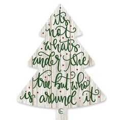 a wooden christmas tree with the words, it's not what is under the tree but