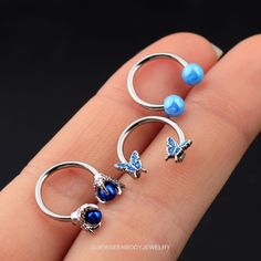 One package includes there pieces blue septum rings. Bar Thickness: 16g(1.2mm); Inner Diameter: 10mm Material: 316L Stainless Steel Blue butterfly,blue dragon claw,blue basic ball Design CBR combination,The combination of this one blue is ubiquitous have small design feeling again already, can match any dress, makeup hair, appear in any occasion. The daith earring is made of 316L Surgical Steel, Hypoallergenic, Nickle and Lead Free, Harmless to Your Piercing and Shorten the Healing Time of Pierc Adjustable Blue Cartilage Earrings, Adjustable Nickel-free Blue Cartilage Earrings, Nickel-free Blue Cartilage Earrings As Gift, Adjustable Blue Belly Rings As Gift, Blue Jewelry With Butterfly Charm For Jewelry Making, Earring Butterfly, Septum Earrings, Daith Earring, Nose Ring Hoop