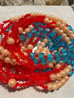 Double Strand Waist Bead "Divo" features two strands adorned with vibrant red crystal glass beads, large square blue crystal glass beads, and luxurious gold round glass seed beads. Immerse yourself in the regal charm and customizable elegance of this waist bead, crafted to add a touch of opulence to your ensemble. 🔴 Vibrant Red Crystal Glass Beads: The first strand showcases vibrant red crystal glass beads, radiating energy and passion. The red beads created a bold and dynamic foundation, symbo Red Faceted Beads Jewelry For Beach, Red Czech Glass Bracelets With Colorful Beads, Double Strand Red Jewelry For Party, Red Glass Beaded Bracelets With Round Beads, Red Double Strand Jewelry For Party, Red Czech Glass Beaded Bracelets With Colorful Beads, Red Double Strand Party Jewelry, Red Czech Glass Beaded Bracelets, Red Beaded Bracelets With Spacer Beads For Party