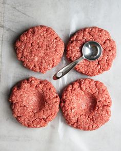 three hamburger patties with a spoon on top