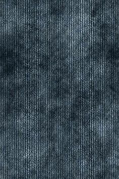 an up close view of the texture of blue denim fabric, which is very dark