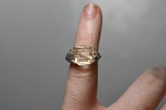 a woman's hand with a ring that has a large yellow diamond on it