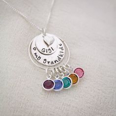 "Personalized Grandma Necklace, Grandmother Necklace, Birthstone Necklace, Love my Grandchildren Necklace, Hand Stamped, Mother's Day Gift This is a perfect Mother's Day Gift for Grandma to show off all of her children or grandchildren. A sterling silver pendant of stacked discs are hammered and hand stamped with her special grandmother name and then bottom disc can be stamped with a special message. A tiny sterling silver heart charm adorns the top of the disc. A sterling silver ring holds all Multicolor Birthday Jewelry With Charms, Multicolor Charm Jewelry For Birthday, Multicolor Charms Jewelry For Birthday, Mother's Day Birthday Gift Charms Jewelry, Nickel-free Necklace For Mother's Day Personalized Gift, Charm Jewelry For Mother's Day Birthday Gift, Handmade Sterling Silver Birthstone Necklace For Birthday, Multicolor Jewelry For Valentine's Day Birthday, Adjustable Birthstone Necklace For Birthday And Mother's Day