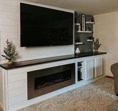 a flat screen tv mounted to the side of a wall above a fireplace in a living room