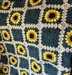 a crocheted blanket with sunflowers on it