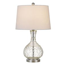 a glass table lamp with a white shade on the base and a silver metal base