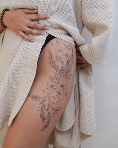 a woman's thigh with tattoos on it