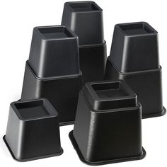 six black plastic pots and one is empty