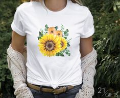 Sunflower Graphic T-Shirt  Our shirts are 100% Premium Cotton "Bella+Canvas" brand with beautiful custom print -- C A R E - I N S T R U C T I O N S -- To prolong the life of the shirt's print please follow these care instructions ▶Washing: Wash inside out with cold water with similar colors using a gentle cycle ▶Ironing: If ironing is necessary, iron inside-out on the lowest setting ▶Drying: Tumble dry on the lowest setting or hang-dry ▶Do not bleach *Actual colors may vary. This is due to the fact that every computer monitor/phone display/tablet has a different capability to display colors and that everyone sees these colors differently. We try to edit our photos to show the samples as life-like as possible, but please understand the actual color may vary slightly. We cannot guarantee tha Spring Sublimation Print Short Sleeve Top, White Sunflower Print Shirt For Summer, White Sublimation Design Top With Custom Print For Spring, Yellow Custom Print Top For Summer, White Crew Neck Sublimation Design For Spring, White Summer Shirt With Sunflower Print, Custom Print Short Sleeve Sublimation Design For Spring, White Crew Neck Shirt With Sunflower Print, White Short Sleeve Top With Sunflower Print