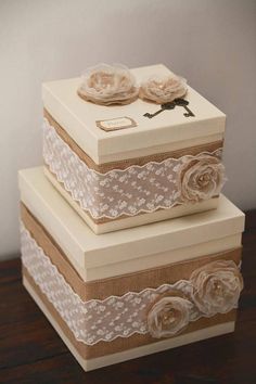 two boxes with lace and flowers on them